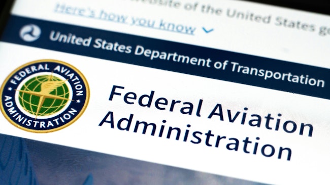 a close-up shot of a computer screen open to the Federal Aviation Administration's website, focusing on the department's logo and headline