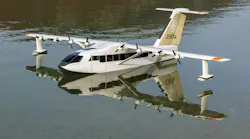 A white airplane floating on a body of water