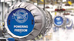 A close-up shot of an airplane engine with a blue graphic in front that reads, 'Pratt & Whitney Dependable Engines Powering Freedom'