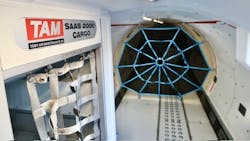 The interior of a plane with no seating and added straps to tie down cargo The interior of a plane with no seating and added straps to tie down cargo