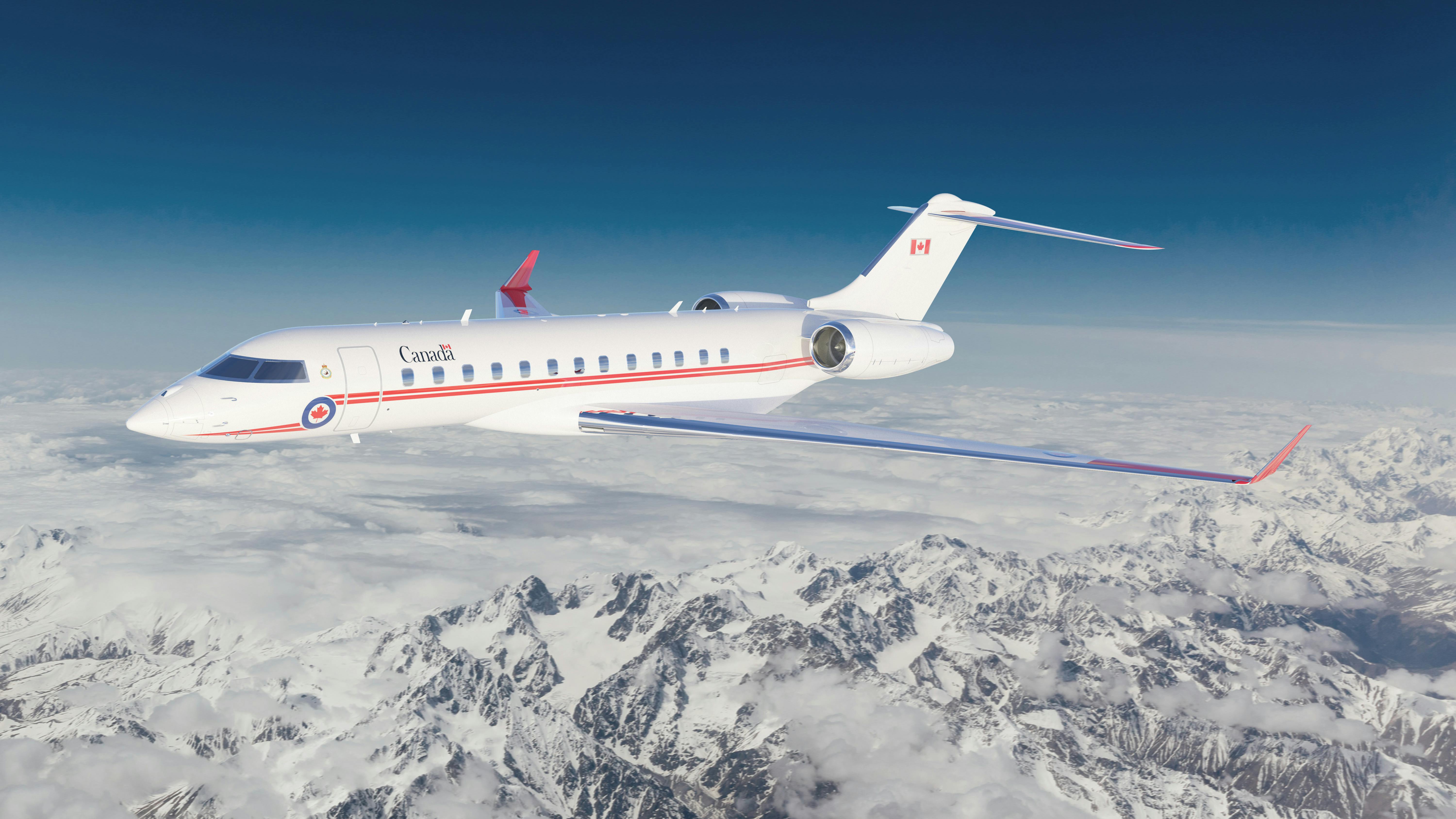 A white airplane with a red stripe sports text that reads 'CANADA' as it flies over snowy mountains in front of a dark blue sky
