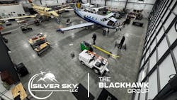 An overhead shot of a maintenance hangar with two airplanes and a variety of tug ground vehicles An overhead shot of a maintenance hangar with two airplanes and a variety of tug ground vehicles