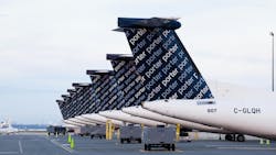 A row of airplanes parked on a tarmac with the word 'Porter' repeated in a decorative pattern on the back of each plane A row of airplanes parked on a tarmac with the word 'Porter' repeated in a decorative pattern on the back of each plane