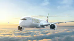 An airplane with the word 'Emirates' written on it flying over clouds in front of a sunny sky