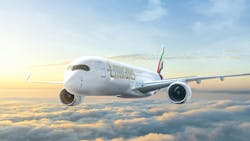 An airplane with the word 'Emirates' written on it flying over clouds in front of a sunny sky An airplane with the word 'Emirates' written on it flying over clouds in front of a sunny sky