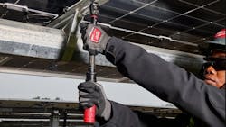 A man wearing a black sweatshirt and protective glasses and gloves holding a large wrench A man wearing a black sweatshirt and protective glasses and gloves holding a large wrench