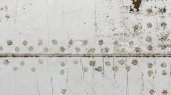 The side panels of an airplane showing corrosion and rust
