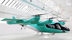 A teal and white eVTOL aircraft with several propellers and a logo on the side that says: EVE A teal and white eVTOL aircraft with several propellers and a logo on the side that says: EVE