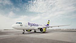 A white airplane with blue and yellow accents and text on the side that reads: flyadeal A white airplane with blue and yellow accents and text on the side that reads: flyadeal