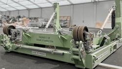 A large green metal stand to hold an aircraft engine with text on it that reads: PROPERTY OF ENGINESTANDS.COM A large green metal stand to hold an aircraft engine with text on it that reads: PROPERTY OF ENGINESTANDS.COM