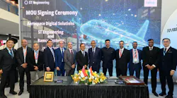 A group of professionals wearing suits standing behind a table and smiling in front of a backdrop that reads: ST Engineering MOU Signing Ceremony Aerospace Digital Solutions