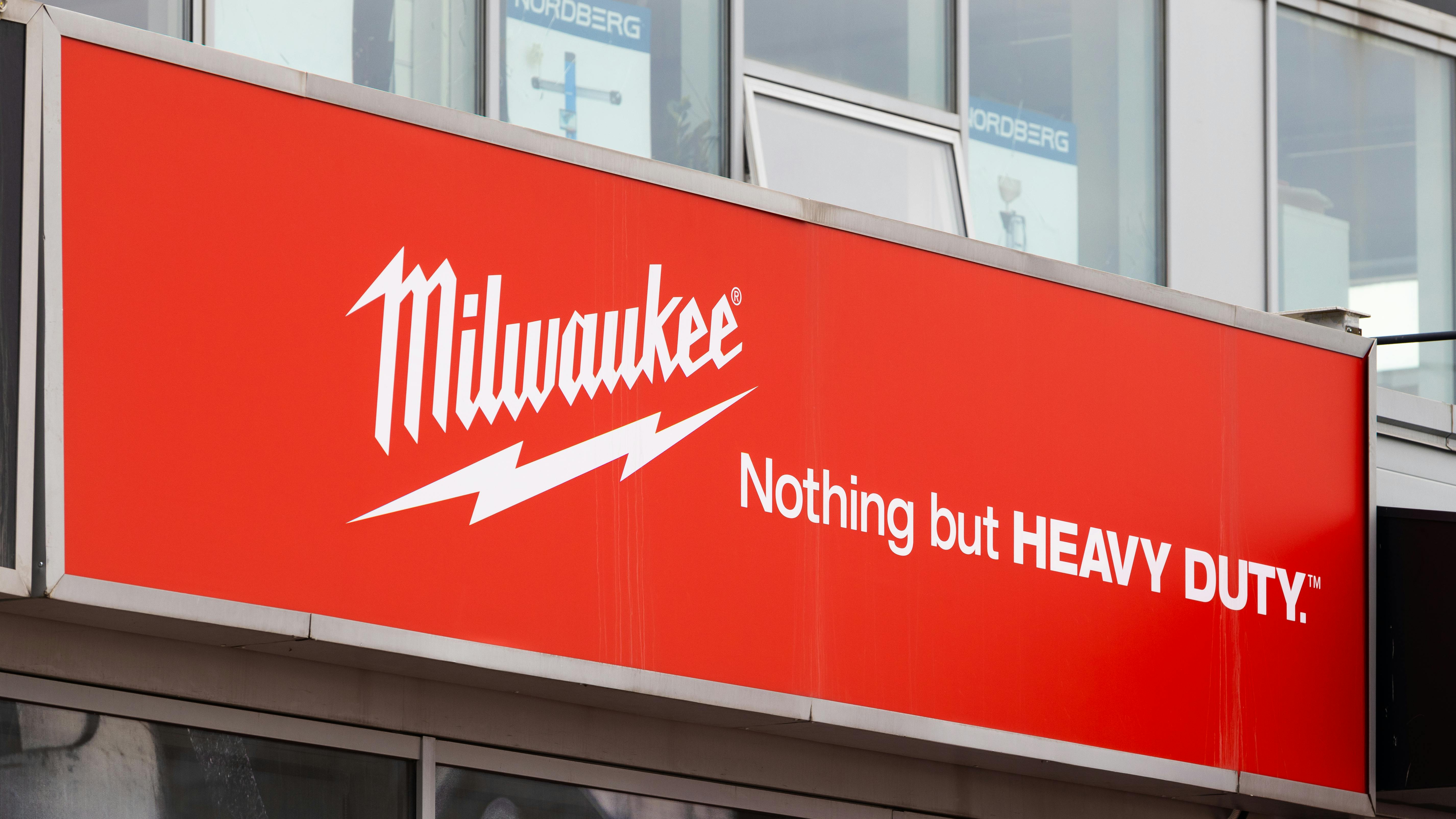 A red billboard featuring white text that reads: MILWAUKEE Nothing but HEAVY DUTY