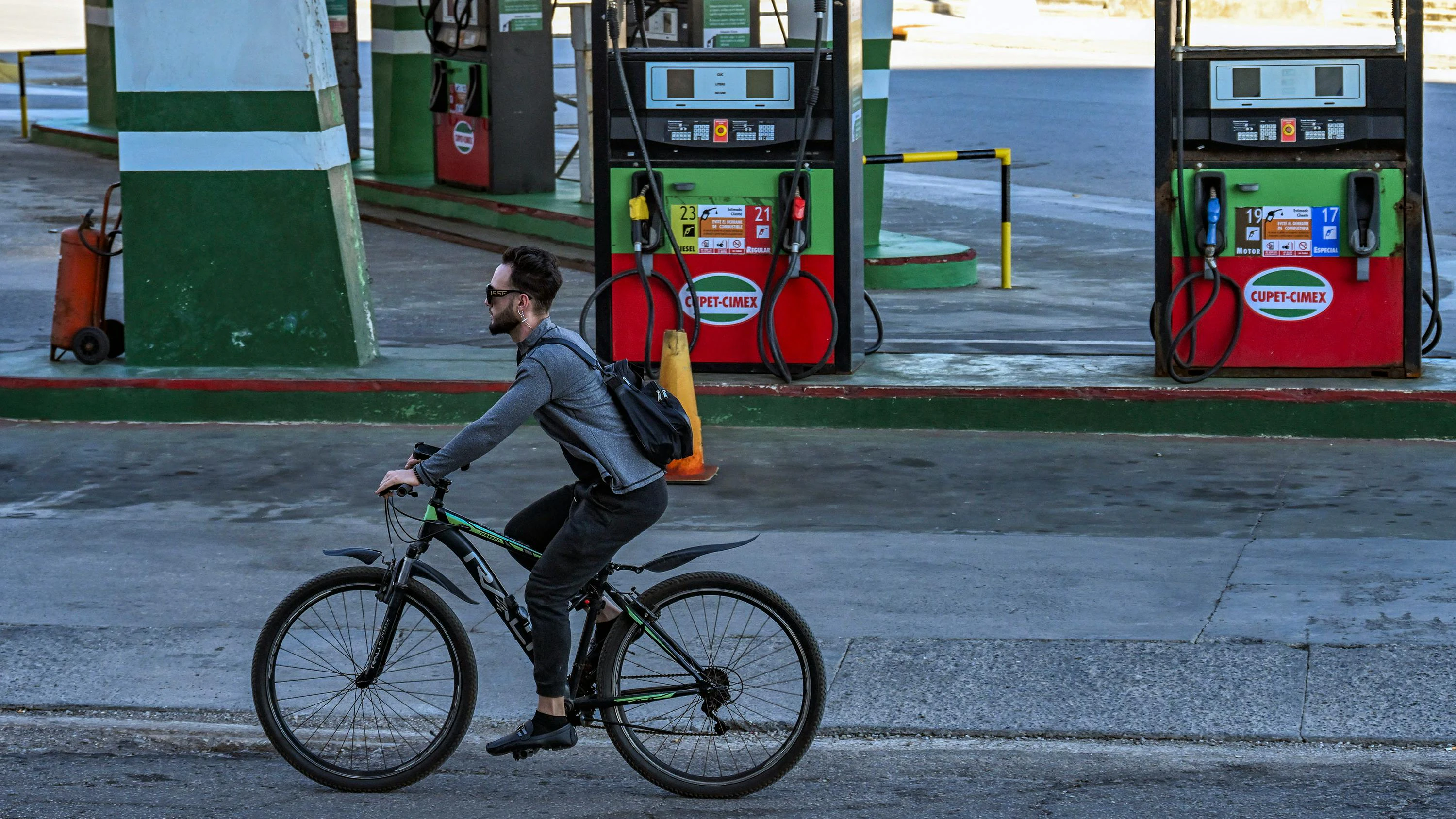 A man rides his bicycle past an empty gas station in Havana on Feb. 19, 2026.