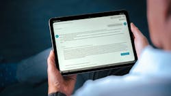 A tablet screen showing text while a person is holding it A tablet screen showing text while a person is holding it