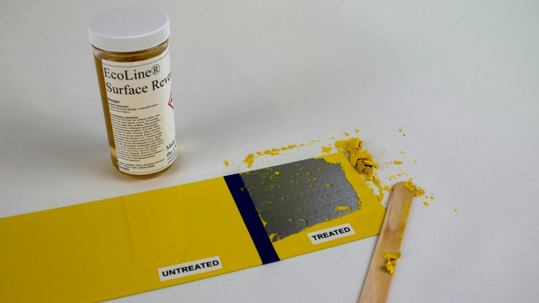 A container labeled 'EcoLine Surface Reveal' next to a piece of metal with some of the paint stripped off