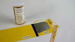 A container labeled 'EcoLine Surface Reveal' next to a piece of metal with some of the paint stripped off