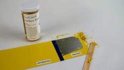 A container labeled 'EcoLine Surface Reveal' next to a piece of metal with some of the paint stripped off A container labeled 'EcoLine Surface Reveal' next to a piece of metal with some of the paint stripped off