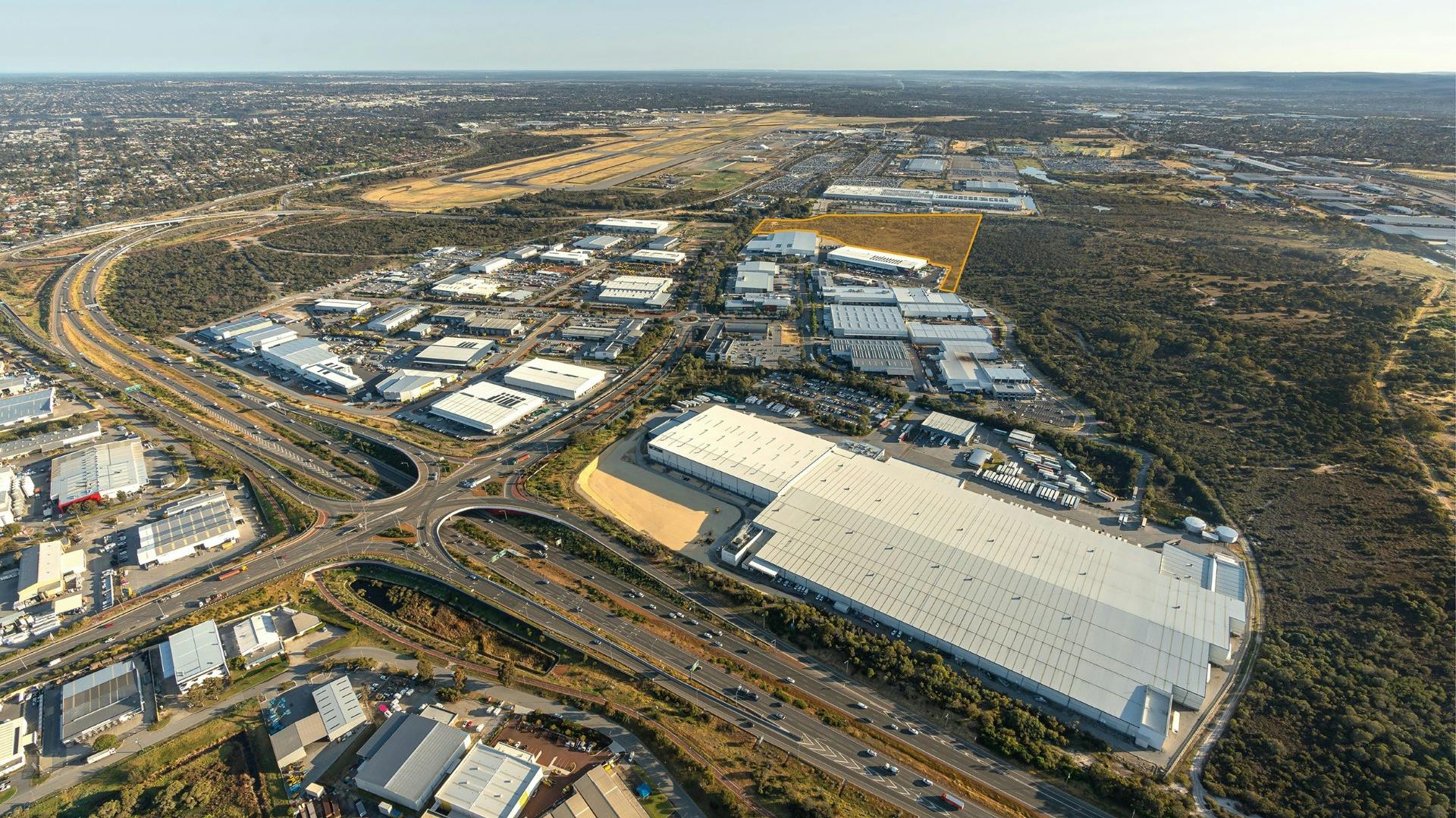 An aerial view of buildings and roads on an airport campus