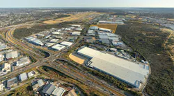 An aerial view of buildings and roads on an airport campus