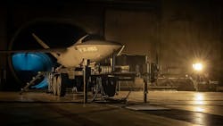 A dark scene of an aircraft with the word 'AIRBUS' printed on the side parked inside a hangar in dim lighting A dark scene of an aircraft with the word 'AIRBUS' printed on the side parked inside a hangar in dim lighting