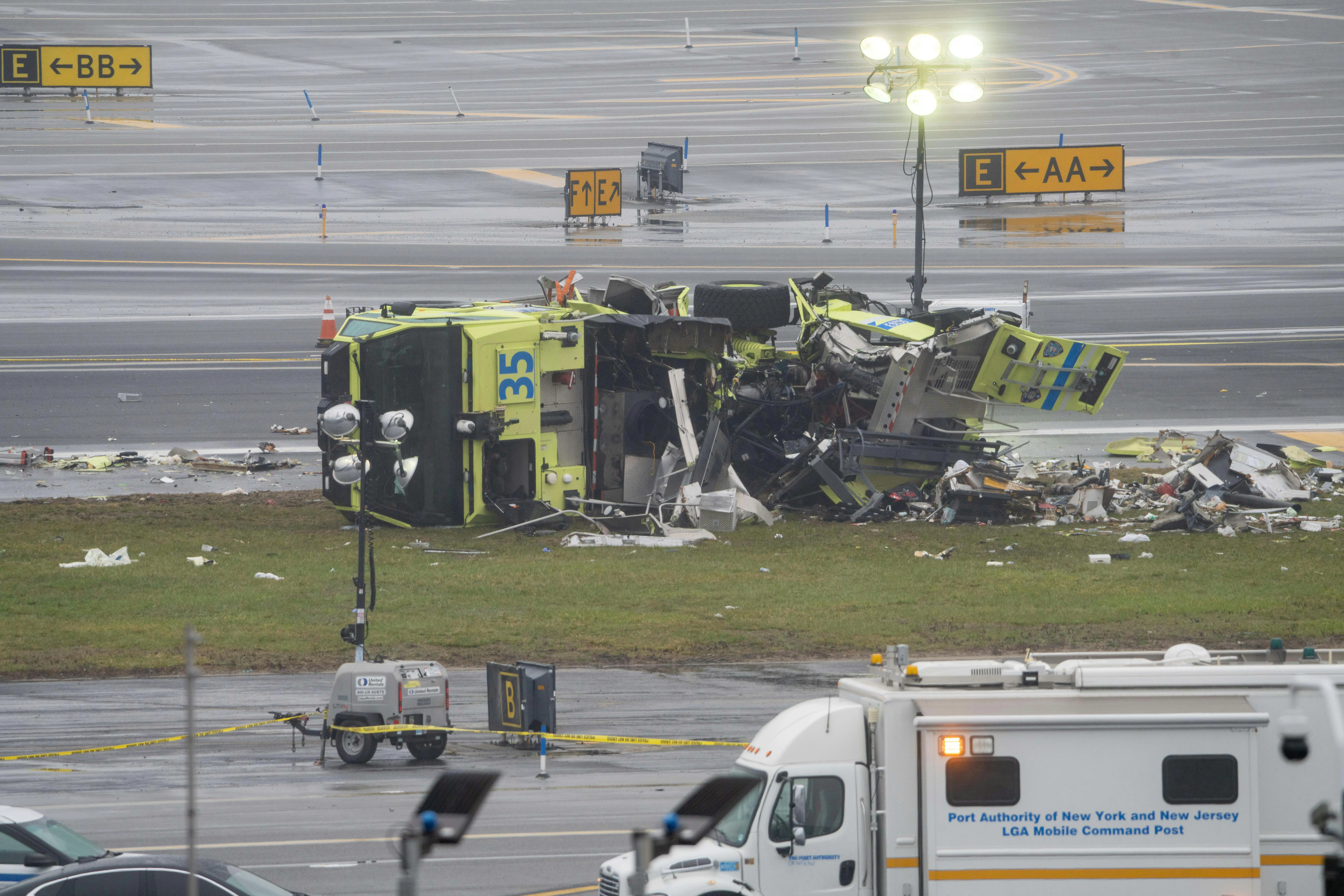 A destroyed Port Authority emergency vehicle is pictured after it collided with an Air Canada Express plane at LaGuardia Airport in Queens, New York, on Sunday, March 22, 2026.