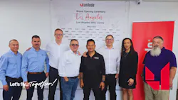 A line of people in business attire standing in front of a backdrop that reads, 'Unilode Grand Opening Ceremony Los Angeles MRO Centre'