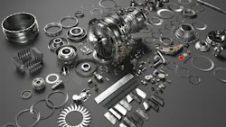 An array of metal airplane parts scattered on a dark gray surface An array of metal airplane parts scattered on a dark gray surface