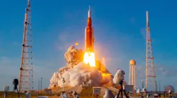 A rocket launching from a station on the ground with flames coming out from the bottom and plumes of smoke A rocket launching from a station on the ground with flames coming out from the bottom and plumes of smoke