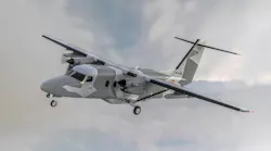 An airplane painted with a camouflage pattern flying in the sky An airplane painted with a camouflage pattern flying in the sky