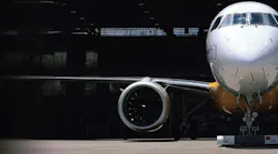 A photograph of a parked airplane, focusing on the engine A photograph of a parked airplane, focusing on the engine