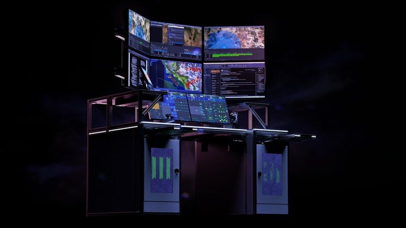 A large computer system with various screens showing geospatial and aviation data