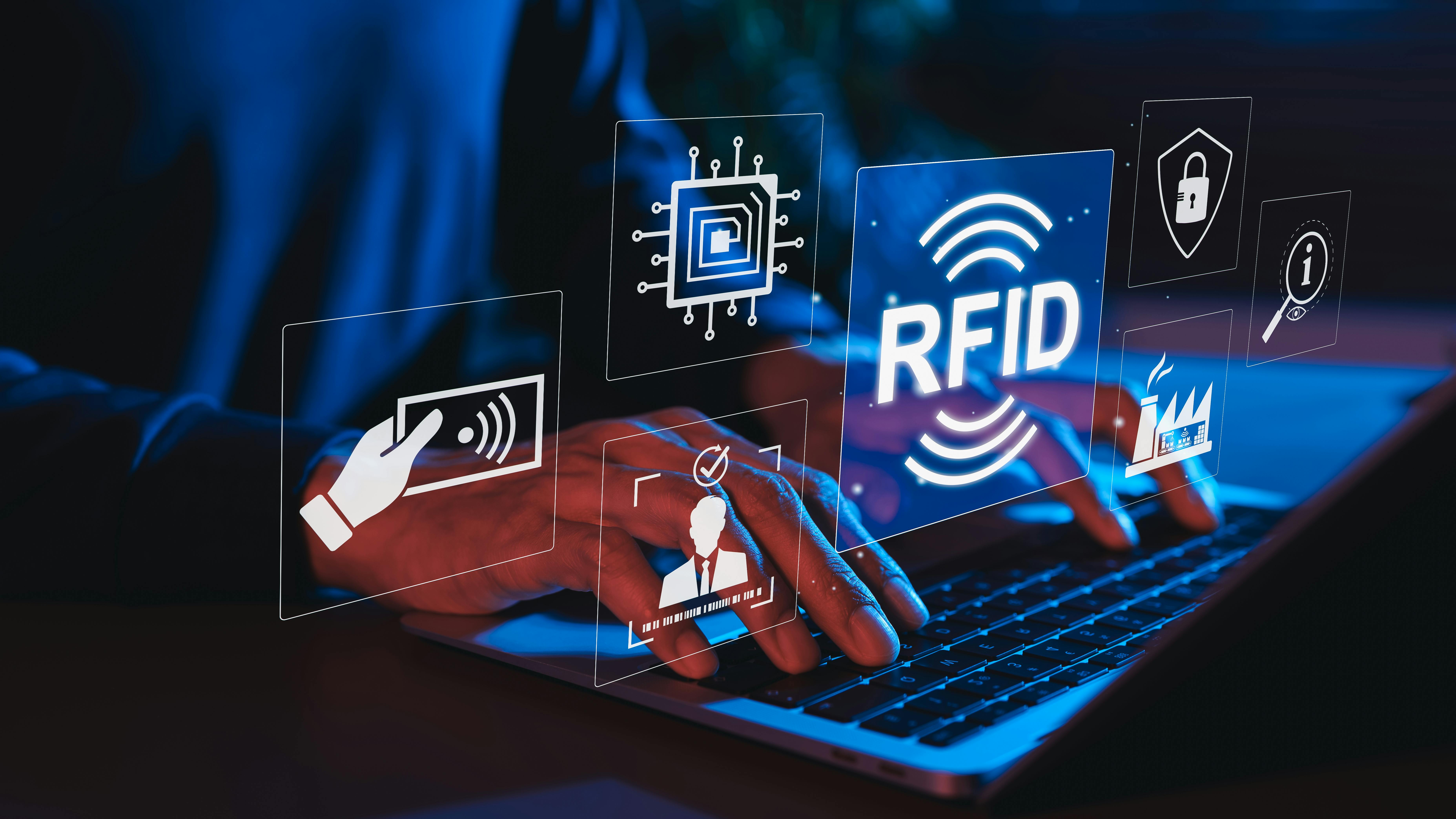 A pair of hands typing on a keyboard with icons floating in the air symbolizing RFID technology, while the whole image is bathed in blue light
