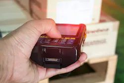 An RFID scanner being used to scan barcodes on cardboard boxes An RFID scanner being used to scan barcodes on cardboard boxes