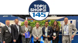A line of people wearing business attire and ID badges smiling at the camera, with one man holding an award plaque, with a graphic at the top of the image that reads: TOP SHOP 2026 the 145