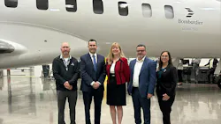 A group of professionals wearing business attire smiling at the camera and standing in front of a white airplane with 'Bombardier Global 7500' printed on the side A group of professionals wearing business attire smiling at the camera and standing in front of a white airplane with 'Bombardier Global 7500' printed on the side