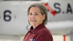 A close-up shot of a woman wearing a maroon polo shirt smiling at the camera A close-up shot of a woman wearing a maroon polo shirt smiling at the camera