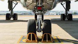 An airplane parked on a tarmac, with the camera zooming in on the tires An airplane parked on a tarmac, with the camera zooming in on the tires