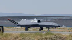 A black military aircraft parked on the ground with white text on the side that reads: YFQ-48A A black military aircraft parked on the ground with white text on the side that reads: YFQ-48A