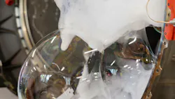 Soap bubbles and foam seeping out of an airplane engine, shown in a zoomed-in photograph Soap bubbles and foam seeping out of an airplane engine, shown in a zoomed-in photograph