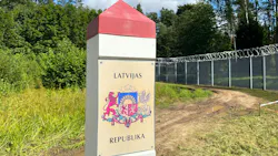 A border marking with a coat of arms and text that reads 'Latvijas Republika' A border marking with a coat of arms and text that reads 'Latvijas Republika'