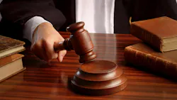 A close-up shot of a judge pounding a gavel on a desk, focusing in on the hand holding the gavel A close-up shot of a judge pounding a gavel on a desk, focusing in on the hand holding the gavel