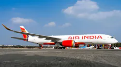 A white airplane with red accents and text on the side that reads: Air India