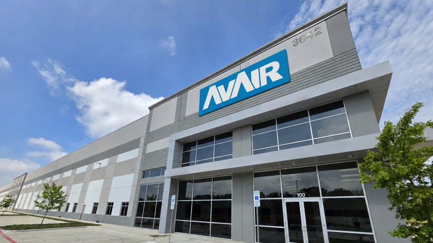 The exterior of a building with a sign on the front that reads: AvAir