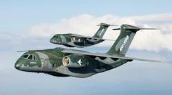 A pair of camouflage-printed military aircraft flying in the sky with 'KC-390' printed on the sides