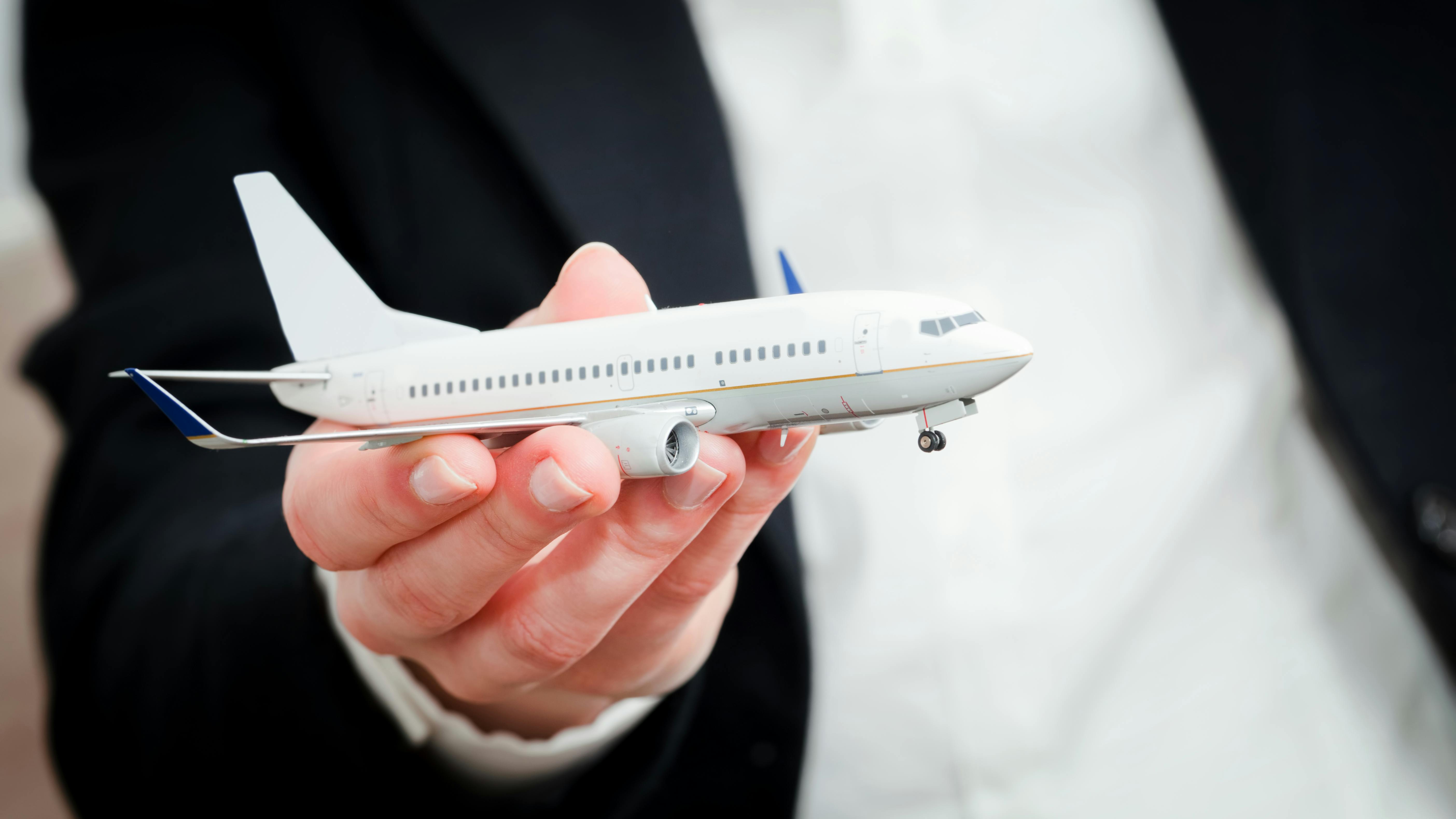 A close-up shot of a model airplane being held in someone's hand