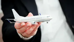 A close-up shot of a model airplane being held in someone's hand A close-up shot of a model airplane being held in someone's hand