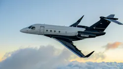A white and black airplane flying in the sky in front of clouds