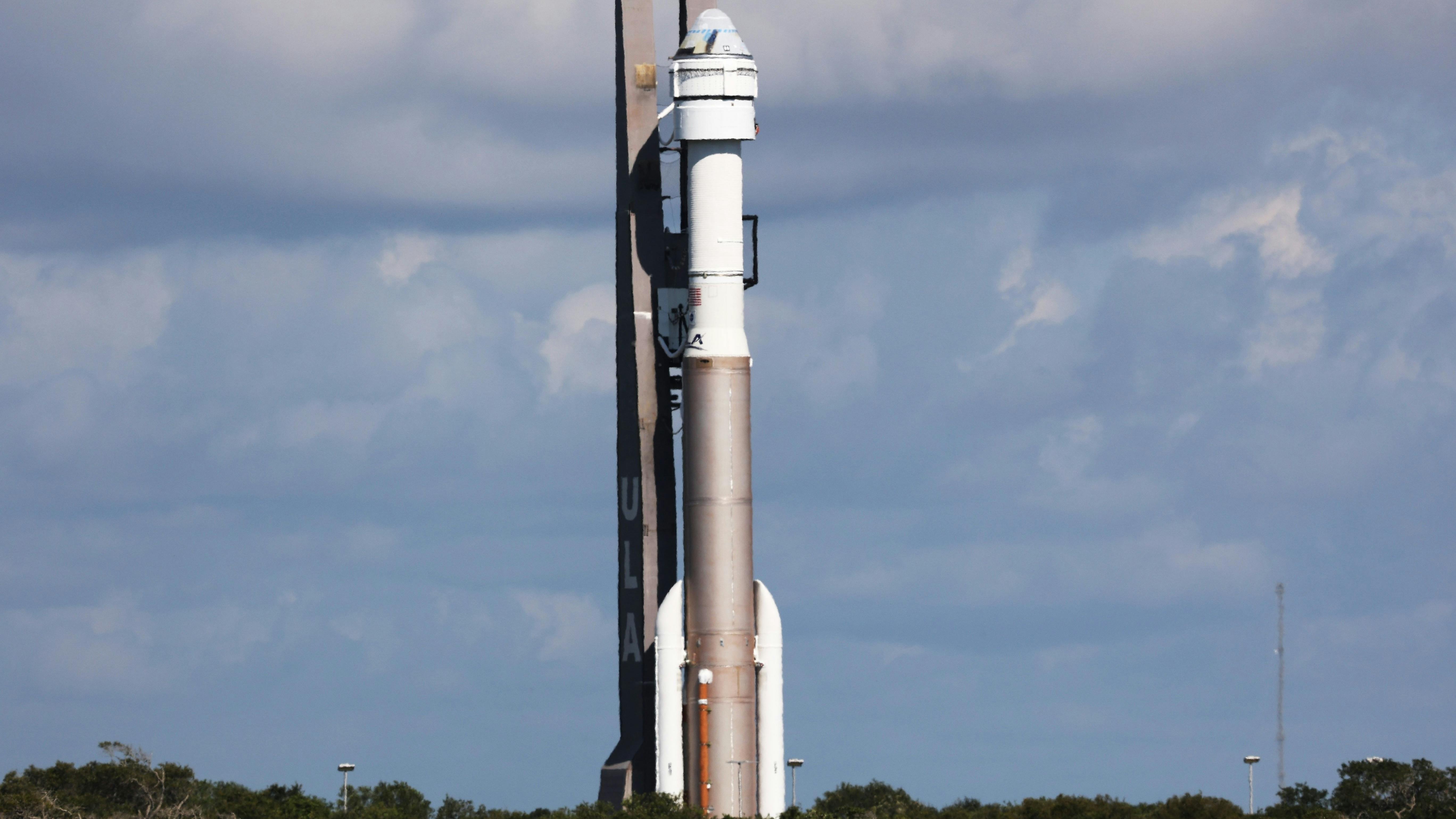 A spacecraft standing at a launch station outside