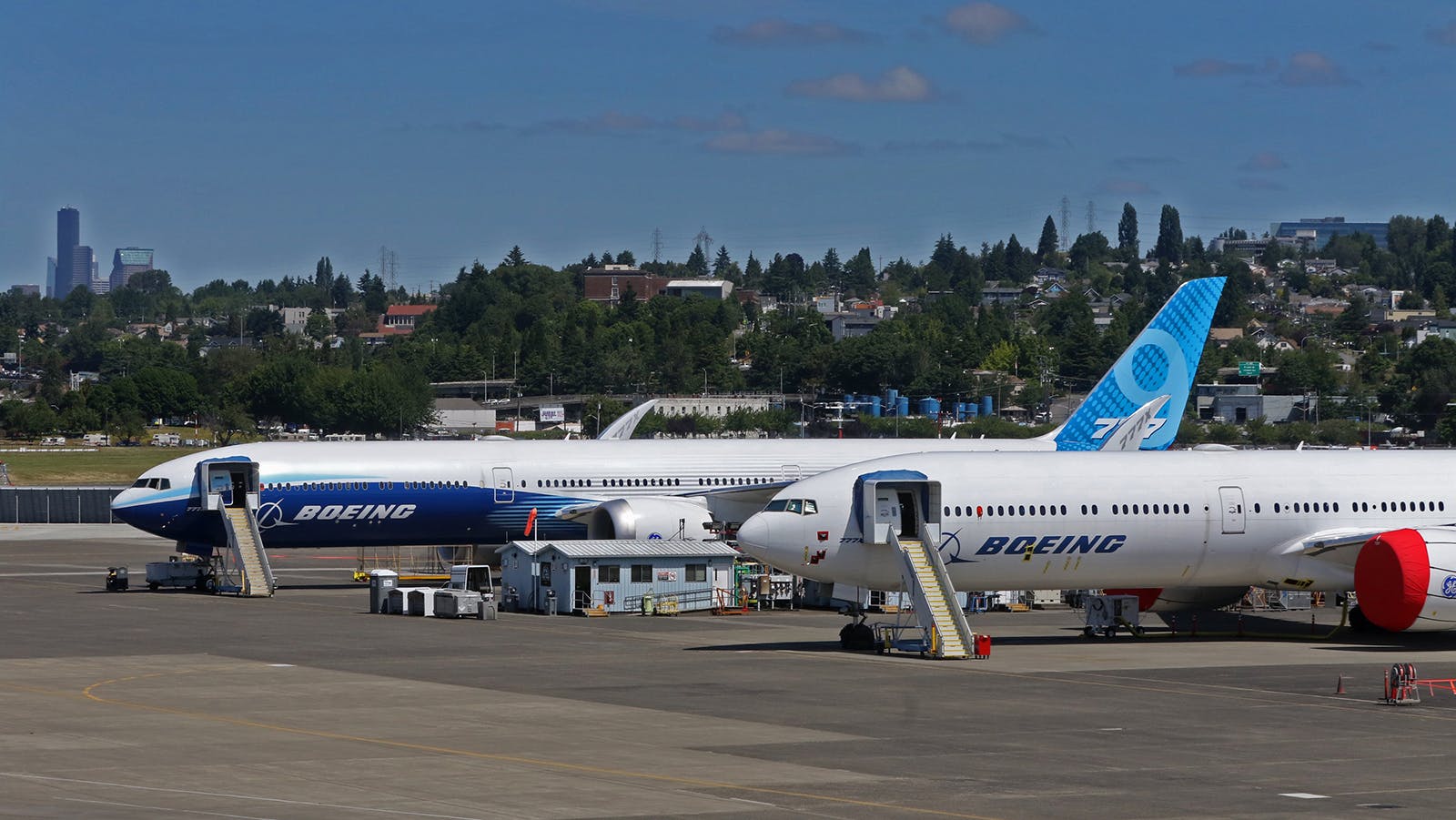 Two Boeing 777X airplanes are parked near the west side of the runway at Boeing Field, Friday, June 18, 2021.