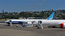Two Boeing 777X airplanes are parked near the west side of the runway at Boeing Field, Friday, June 18, 2021.